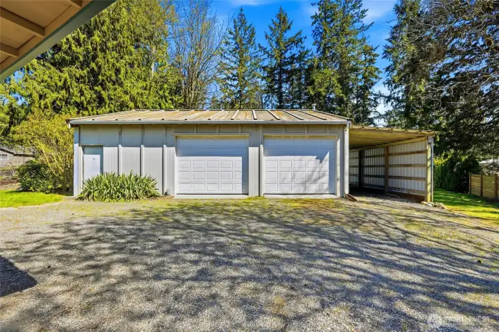 Featuring a massive 1,080 sq ft detached shop with heated workspace, extra refrigerator, 10x30 enclosed tool shed, 12x28 carport