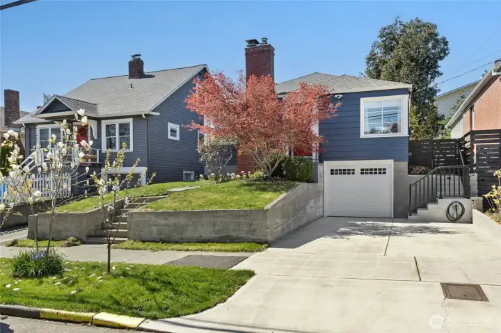 Modern convenience #1 - expanded driveway to accommodate 1 car parked IN the garage, and 1 car parked IN the driveway plus an EV charger.