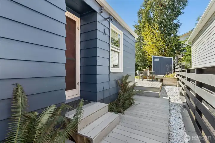 Side door off the kitchen leads to the amazing back yard!