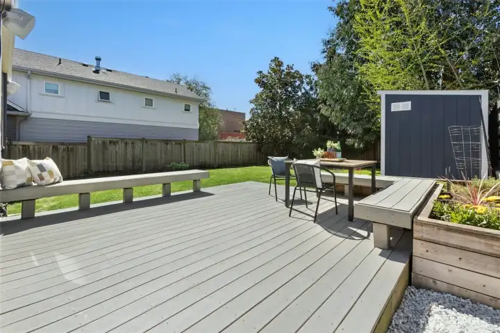 Large, sunny composite deck with a wonderful grassy fenced backyard.