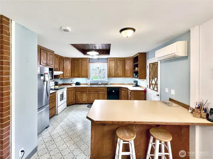 Kitchen offers bar area, lots of cabinets and counter tops.