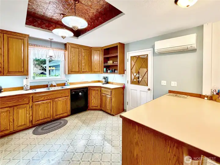 Closer view of kitchen, door to the right leads to huge laundry room/pantry with access to garage.