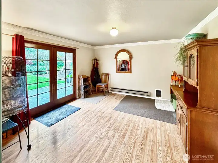 Large family room off dining room with french doors leading to patio and private rear yard.