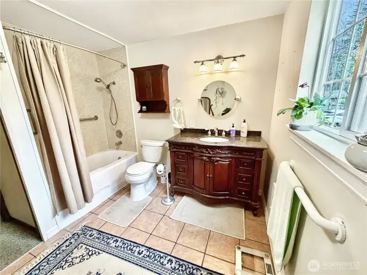 Ample main floor bathroom with tile floors.