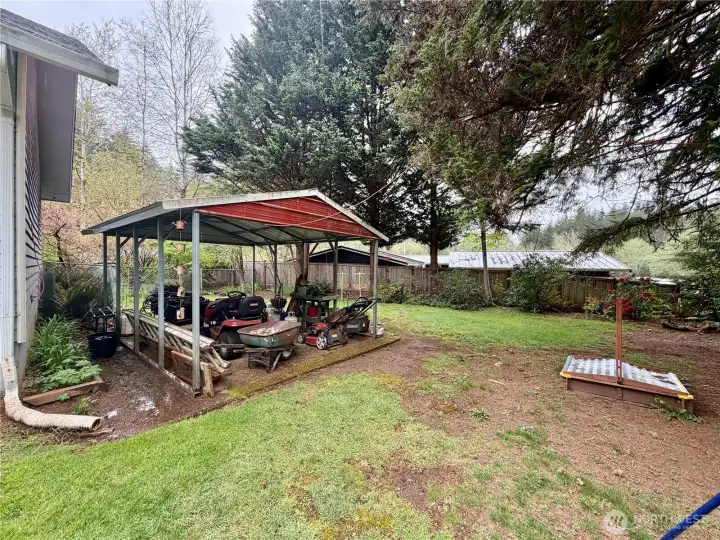 Metal lien-too offers storage for lawn equiptment.