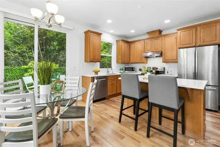 Kitchen and dining rooms seamlessly flow together. Attractive dining room light fixture installed in 2025.