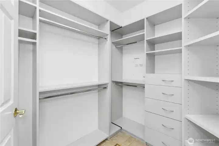 Built in organizers help you make the most of this walk in closet.