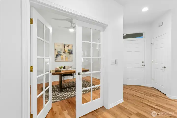 Elegant French doors separate second bedroom from living space.