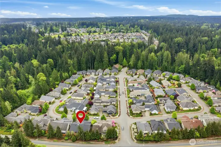 Large Trilogy community surrounded by natural beauty! Aerial view of immediate neighborhood shows popular Redmond Watershed Preserve to the right (access to trail system is just up the road) plus additional parts of Trilogy, including clubhouse and sports courts, in distance.