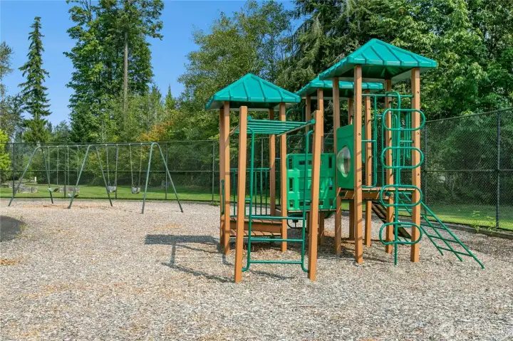 Playground near sports courts has restrooms nearby.