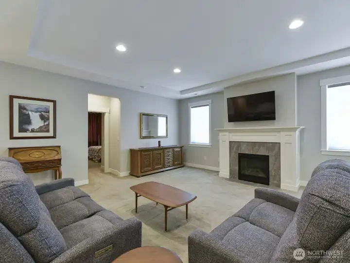 Large living room has a cozy gas fireplace,