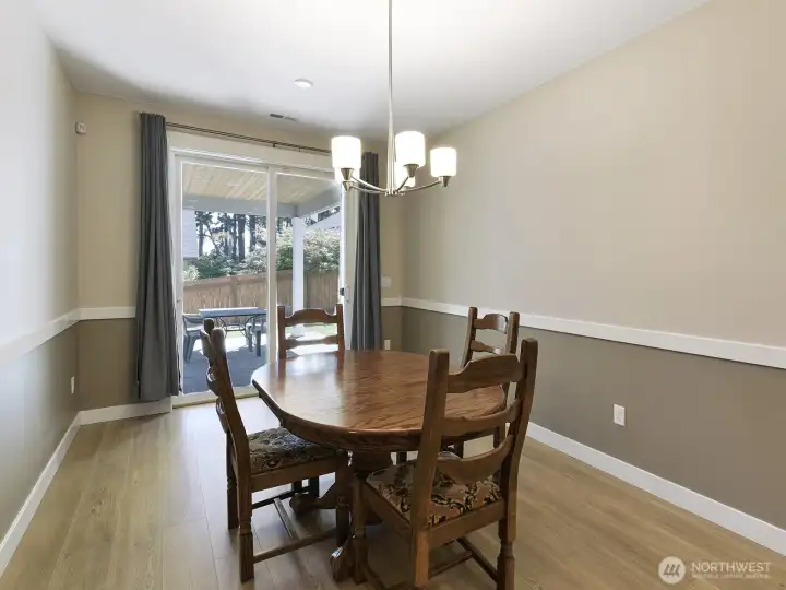 Steps from the kitchen to a formal dining room that leads on to a covered patio.