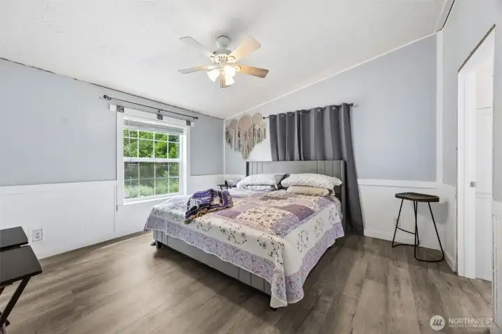 The split floor plan places the Primary suite on its own side of the home offering privacy a quiet retreat. The vaulted ceilings create a spacious and relacing atmosphere.
