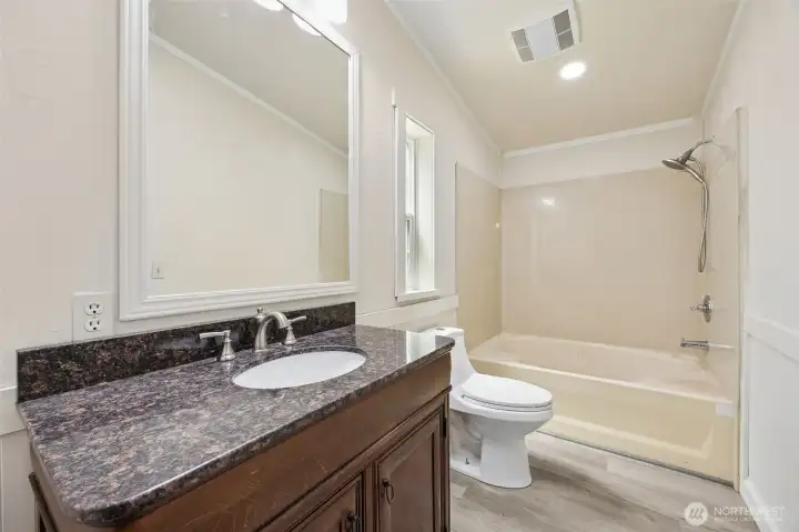 The Primary En Suite has new LVP Flooring and a cultured marble shower surround. It’s durable and easy to clean.