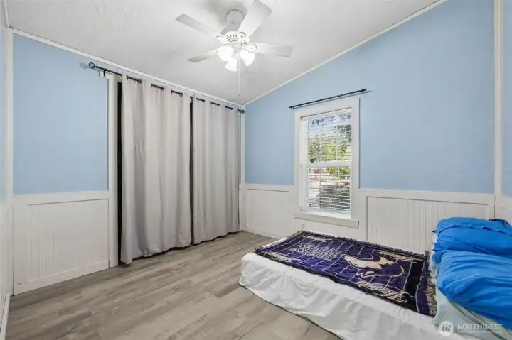 Bedroom #2. With stylish wainscoting. The home features a high-efficiency heat pump ensuring year-round comfort. Enjoy warm winters and cool summers with lower energy costs. It’s a smart upgrade that pays off daily. Central cooling keeps the home crisp on warm days. The system distributes air evenly for consistent comfort. Perfect for Washington’s summer heat waves.