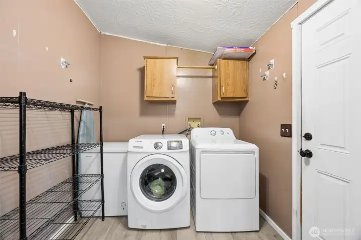 Spacious Laundry room with access to the back deck with premium Trex decking, 8x8 shed, and parking.