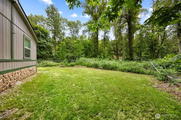 Expansive backyard ready for outdoor living. Whether you envision gardening, play space, or entertaining, there’s room for it all. A rare find in this community.