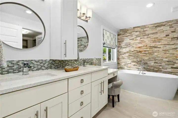 The spa-inspired primary bath pairs clean modern finishes with warm natural textures, creating a space that feels both refined and relaxing.