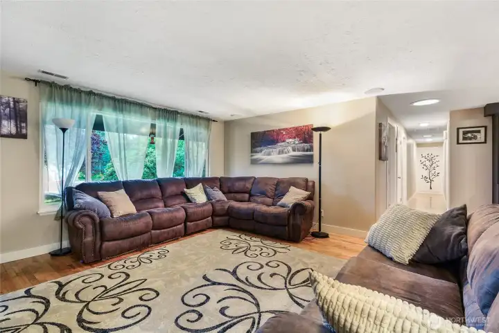 Living room with plush sectional, large windows, and tons of natural light