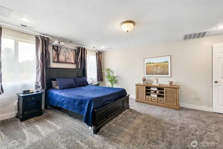 Spacious primary bedroom with lots of natural light!