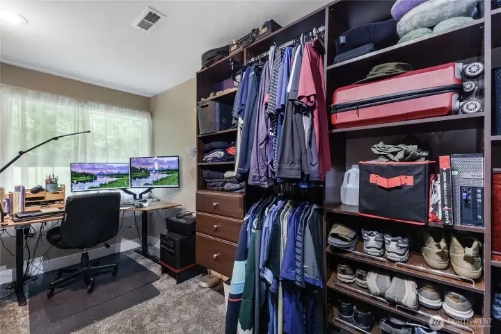 Walk-in closet with cozy built-in office nook — thoughtfully designed