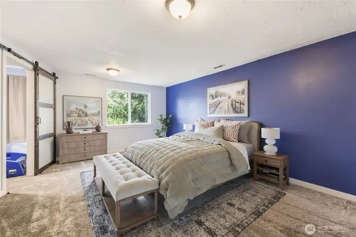 Bright second primary bedroom with beautiful blue accent wall — inviting and stylish