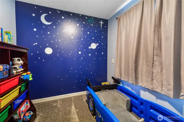 Adorable nook off second primary bedroom with night sky mural — sure to delight! Can also be used as a 2nd closet, home office, craft, or work out area.