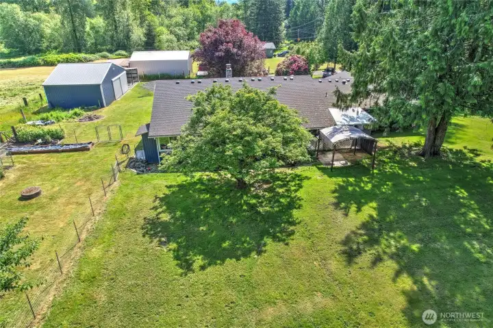 Aerial view — full property with home, shop, and stunning grounds
