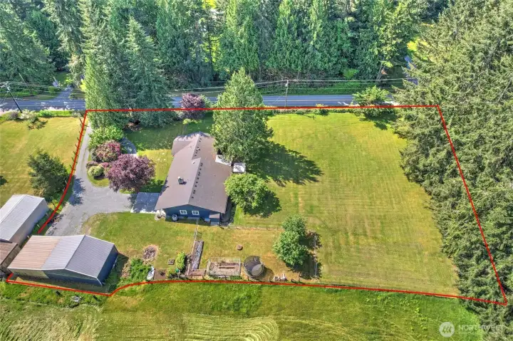 Aerial view showcasing the home, outbuildings, and gorgeous acreage