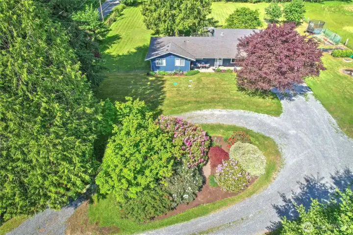 Aerial view highlighting the circular driveway and mature landscaping