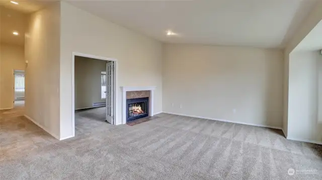 The living room offers the perfect ambiance with the natural light and the cozy fireplace.
