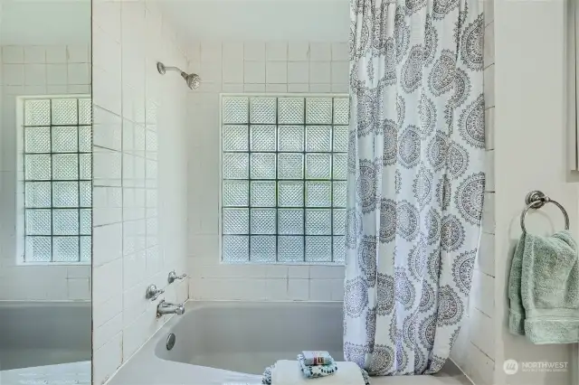 Beautifully tiled and bright shower/tub.