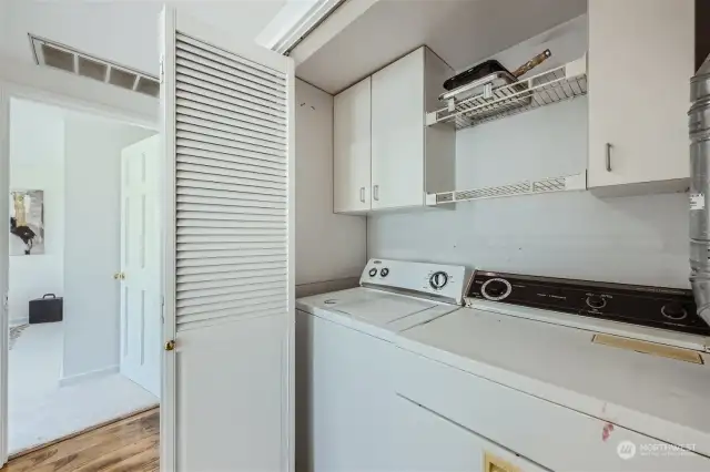 Closet with storage for washer/dryer.