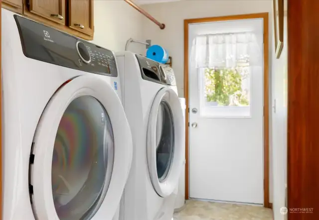 Laundry room with door to back patio.