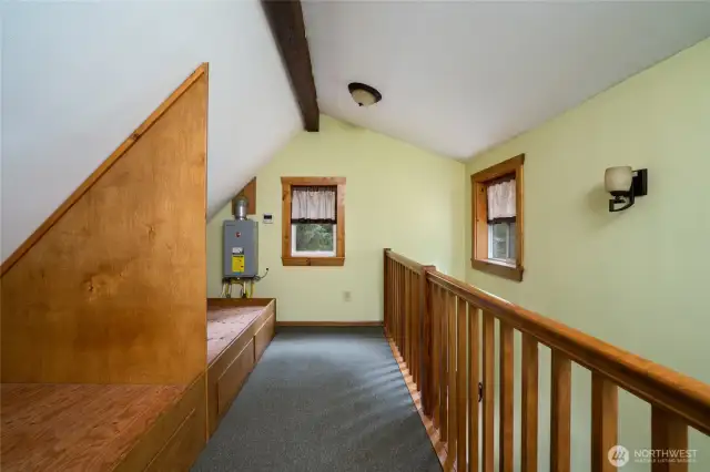 Loft with two built-in bunk spaces. Tankless water heater also visible.