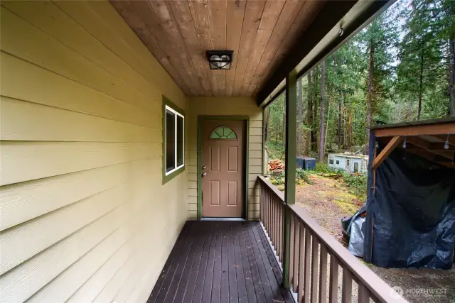 Covered front porch with wood lined ceiling. Deck and railings have been well maintained!