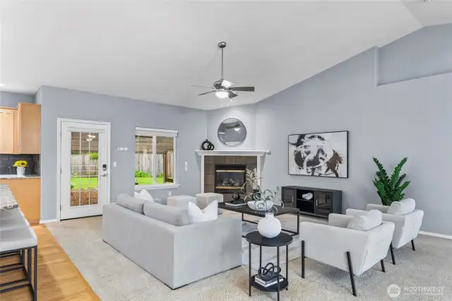 The inviting fireplace, framed by a beautiful tile surround and mantle, creates a warm and welcoming ambiance. It’s the perfect spot for guests to gather, relax, and enjoy the cozy atmosphere!
