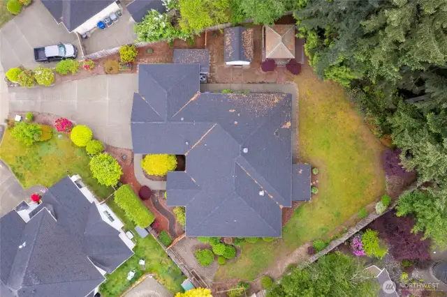 The fully enclosed yard ensures effortless entertaining, while the mature landscaping and trees offer serene views from every window.