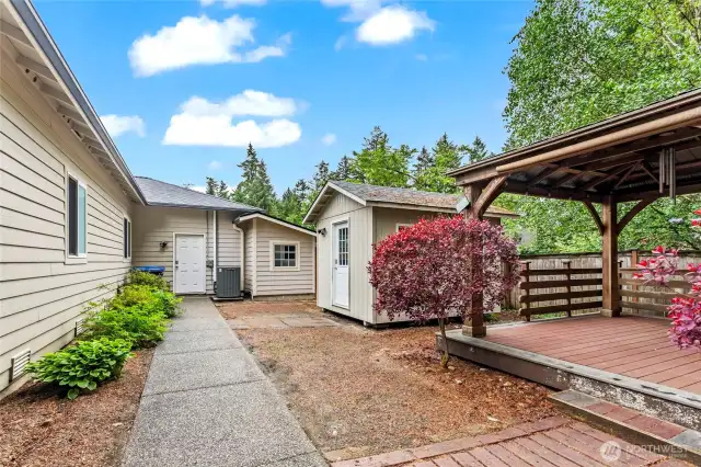 Looking to expand your outdoor entertaining area? The pergola is now equipped for gatherings, featuring a newly installed Trex deck and shades designed to provide relief from the summer heat.