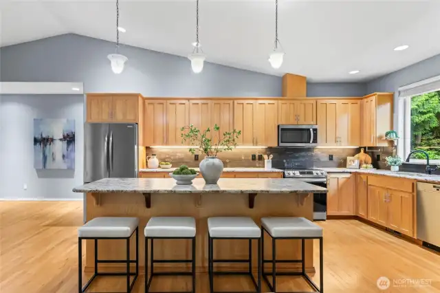 The heart of the home, the kitchen! A large, eat-in-island, granite countertops, and a full tile backsplash are some of the details that make this home desirable. A new refrigerator as well as a recently updated range and microwave make moving in a breeze.