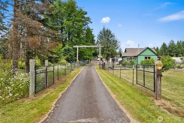 Gated asphalt drive way -one of two gated entry points