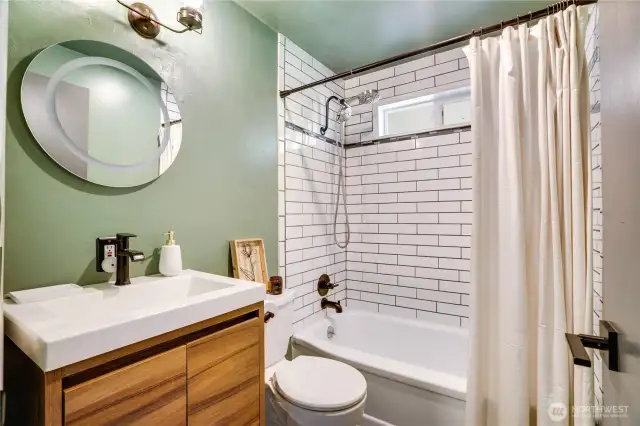 The full bath has been completely updated with tile shower surround, vanity with storage and modern fixtures!