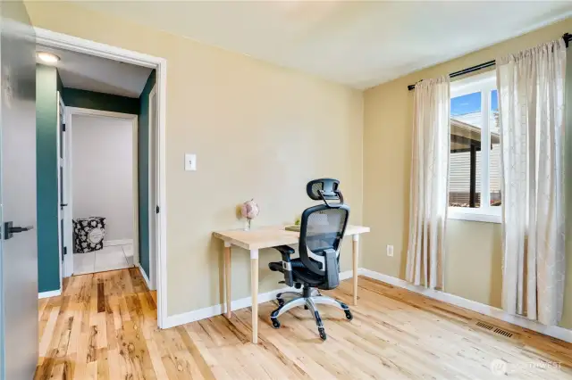 Note the refinished hardwoods flowing through the bedrooms and hallway, and the inset vent covers create a seamless look.