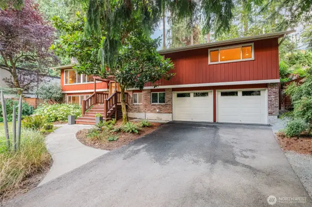 2 car garage with level 2 e-vehicle charger, ample storage. Plus a detached car port!