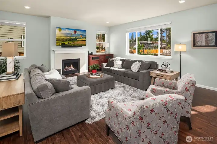 Large living room with gas fireplace.  Television stays!