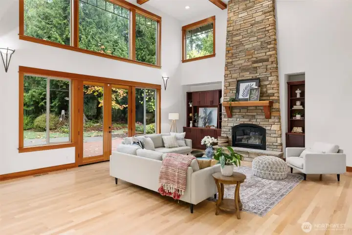 Great Room with double height box beam ceiling and expansive windows