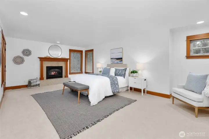 The generously sized upstairs Primary bedroom features a propane fireplace and en-suite bathroom