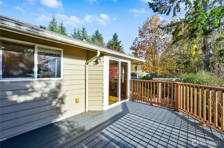The top-level, weather-resistant deck is just off of the dining area by the sliding glass door.