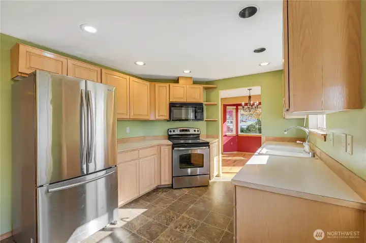 Enjoy stainless steel appliances, real wood cabinets, and easy-to-maintain vinyl floors in the kitchen.