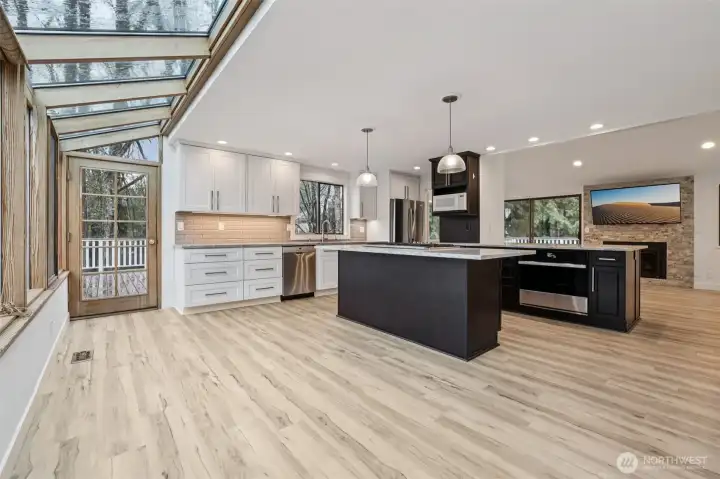 Kitchen looking from wall of windows to back deck
